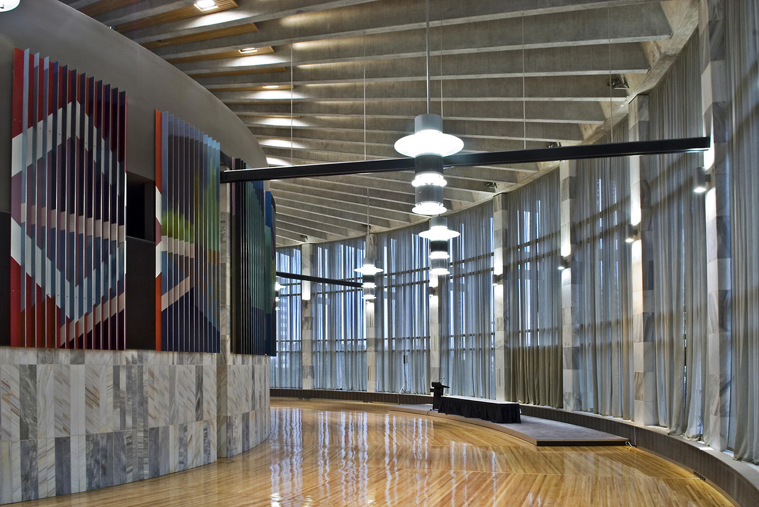 photo of large, marble clad hall with stage set up