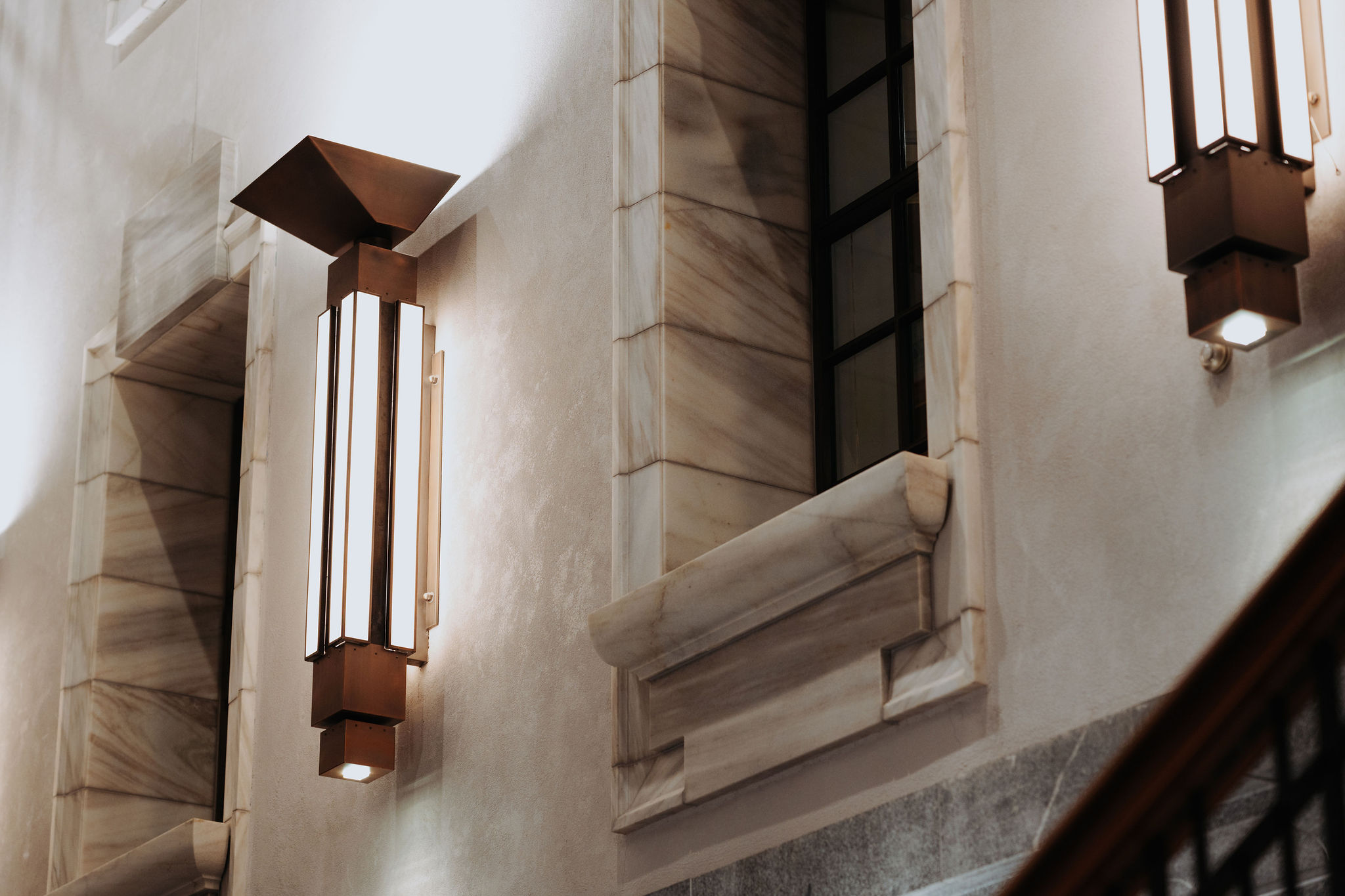 close up photo of architecture detail from Galleria showing marble window frames and art deco style light fittings