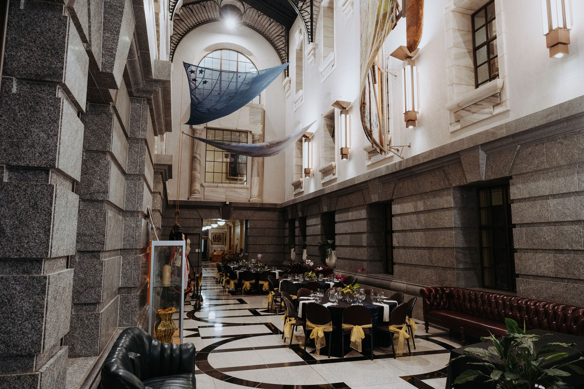 wide photo of multiple tables setup for dinner in Galleria. 