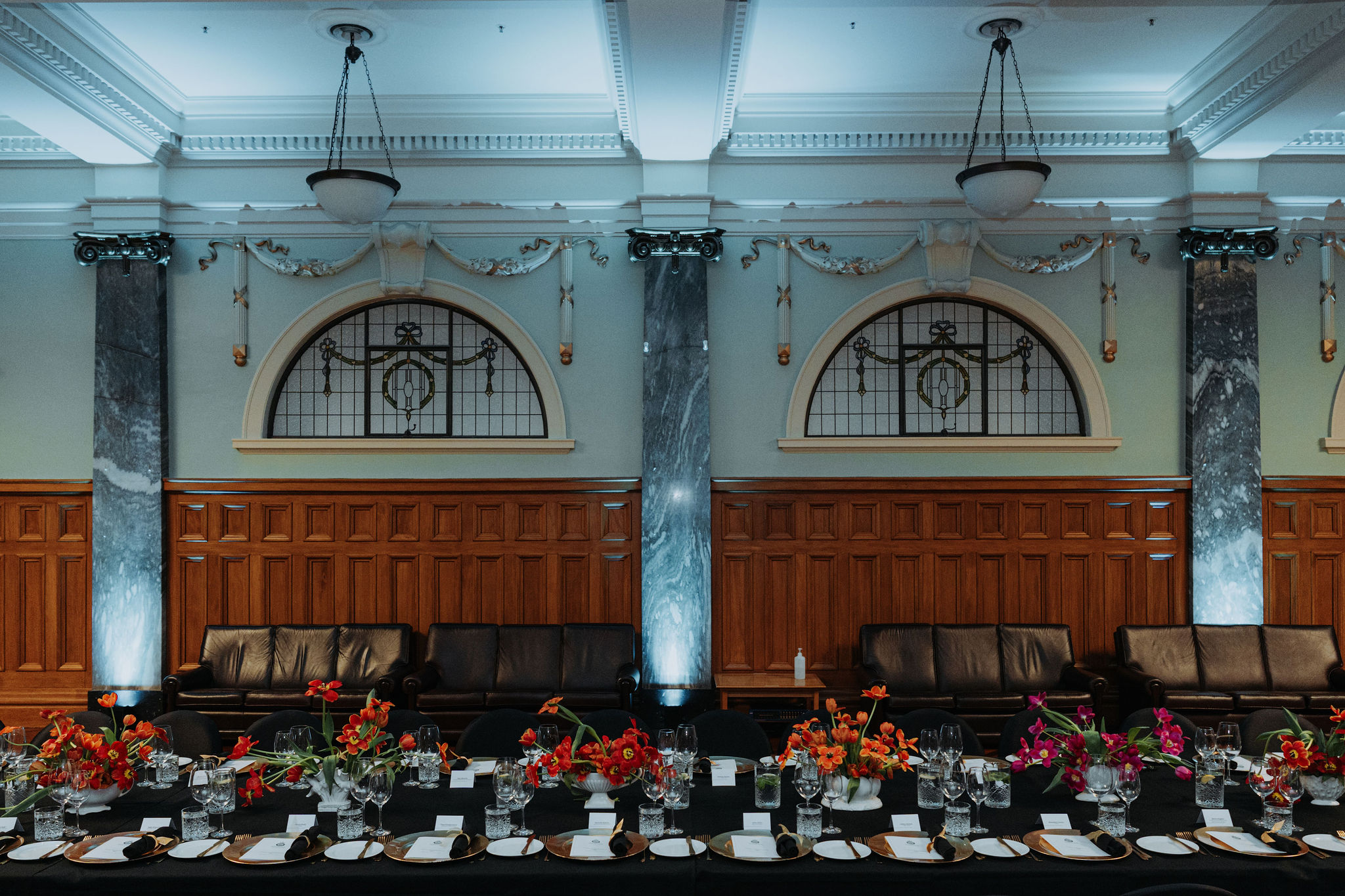 wide photo from side of long table setup for dinner in Grand Hall