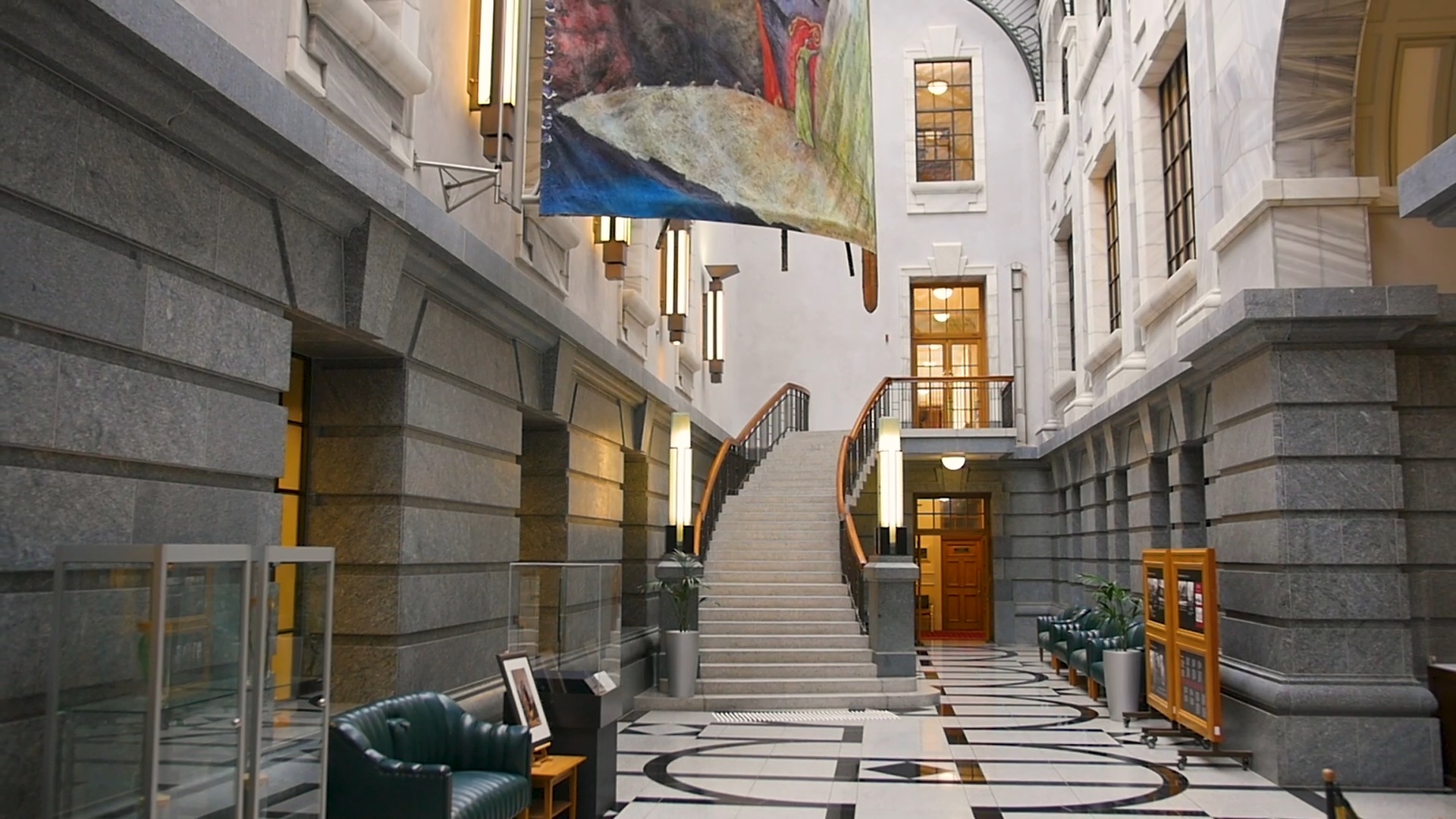 photo of Galleria space showing marble staircase at far end and part of large hanging artwork above