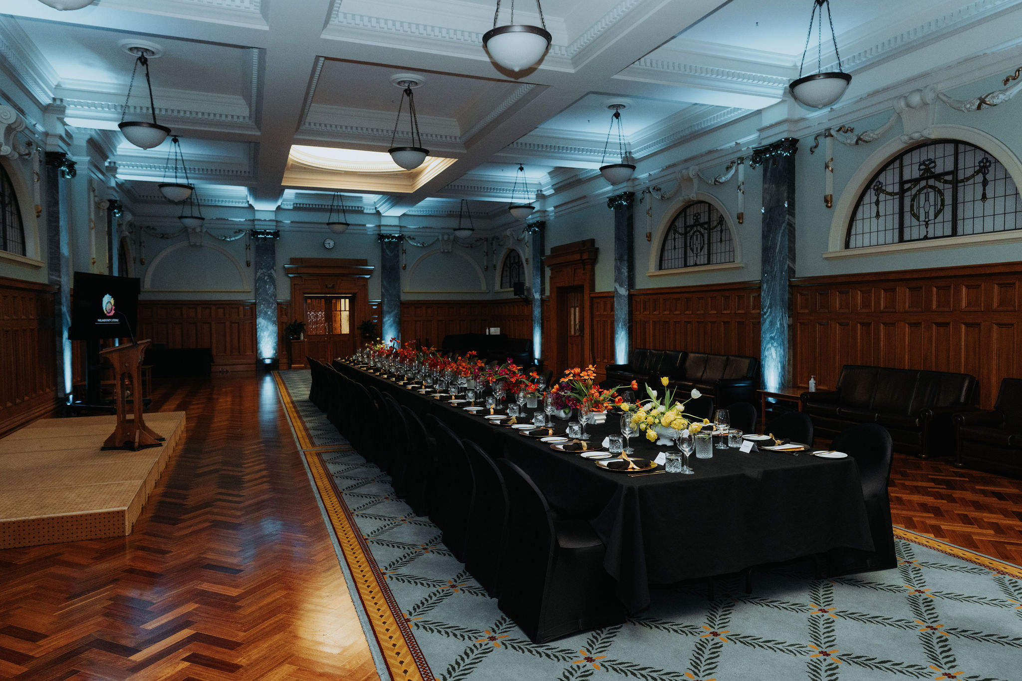 wide photo of long table setup for dinner in Grand Hall 